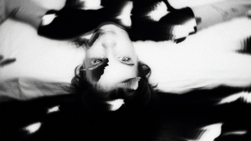 ДОТИК — Upside-down black-and-white portrait in a fragmented reflection